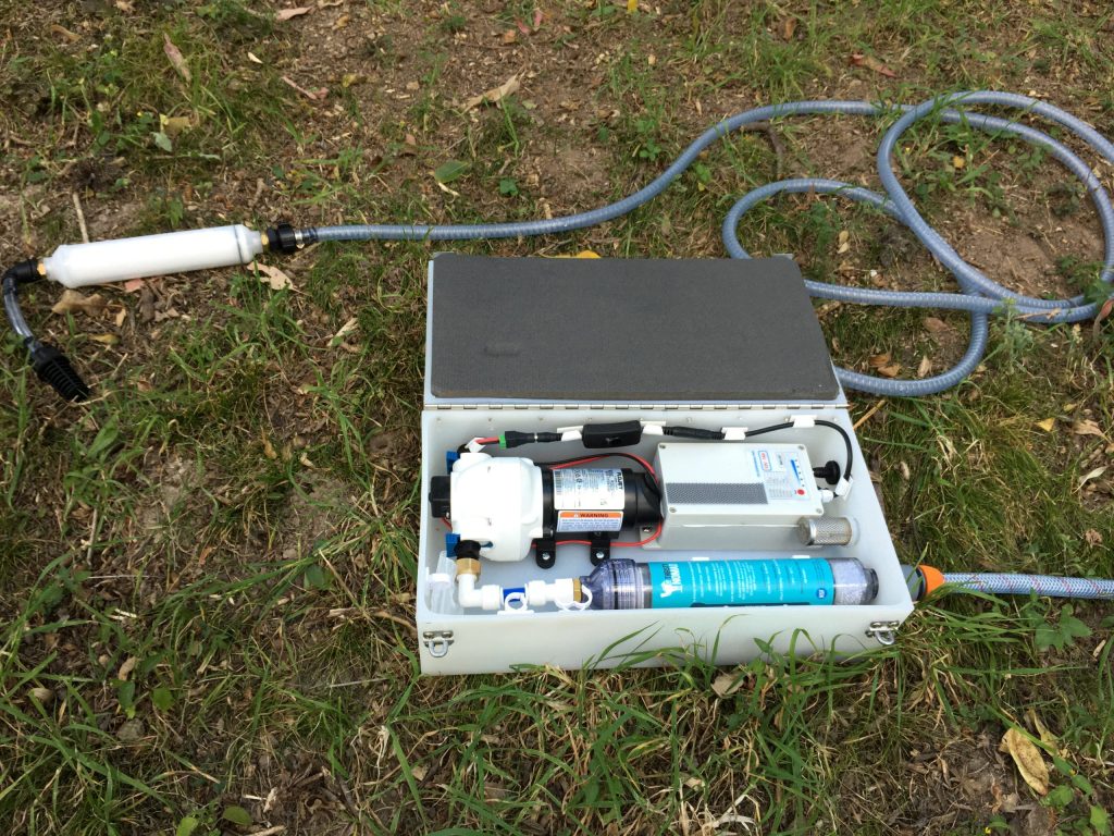Caravan water filter setup outdoors